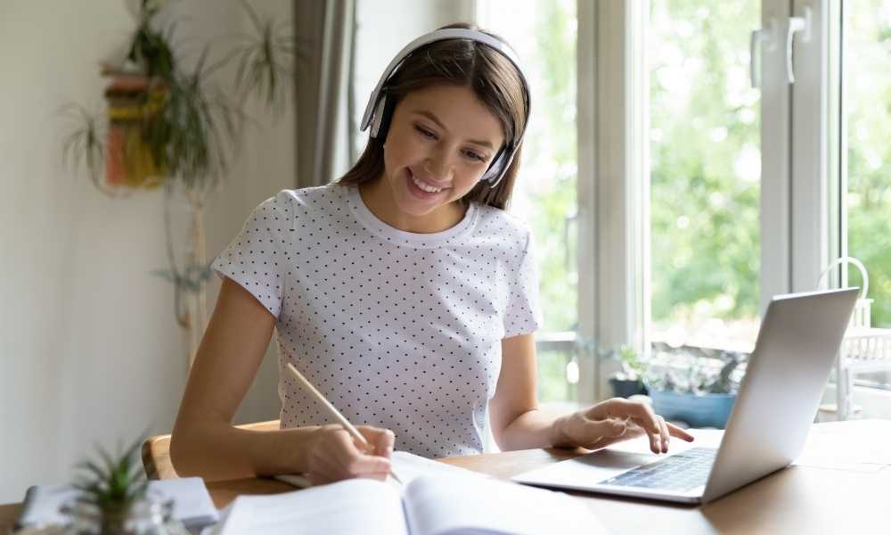 Girl studying at table with headphones