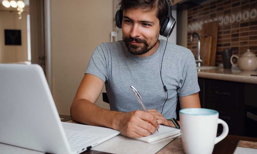 man studying with headphones and coffee
